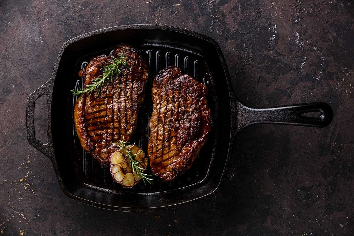 Grilled black angus steak striploin on nonstick iron grill pan