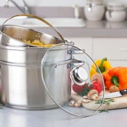 A double boiler with bell peppers and spices at the side, Should the Water in a Bain-Marie (Double Boiler) Be Hot?