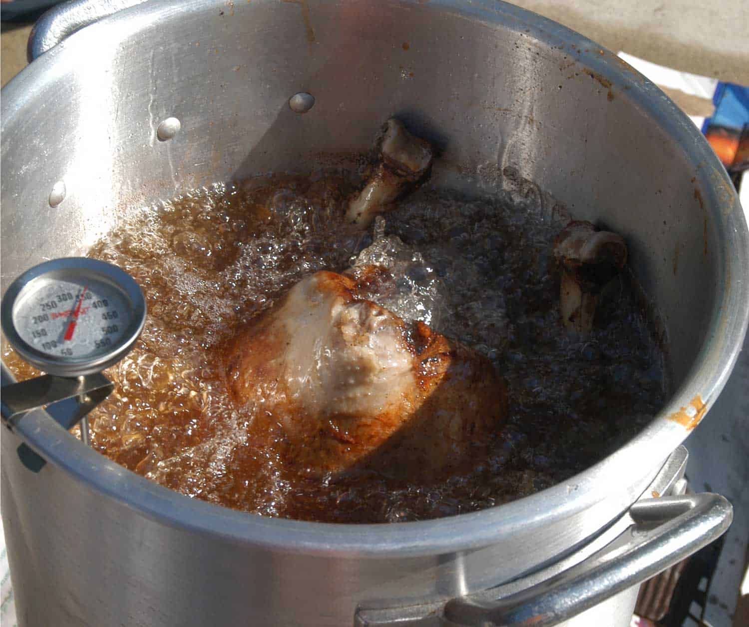 A full-size turkey being fried in peanut oil