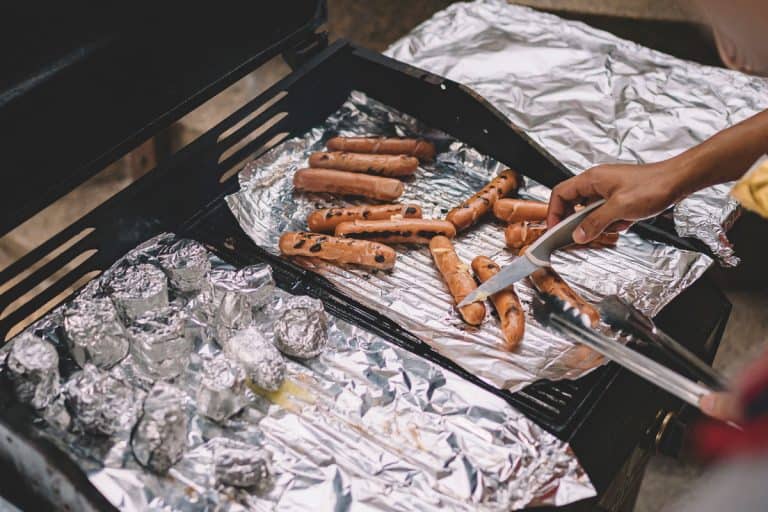Man cooking hotdogs and placing them on aluminum foils, Easy Baking Paper Sheets Alternatives