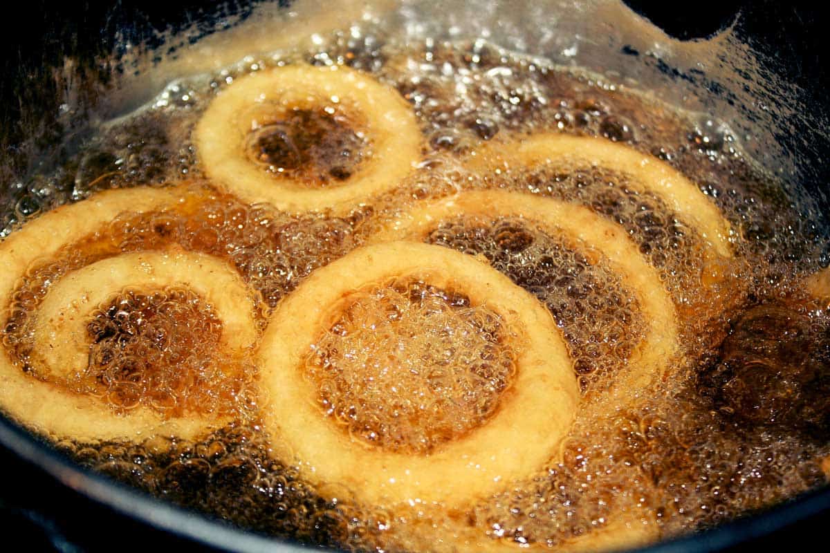 Onion Rings cooking in hot bubbly oil in a deep fryer
