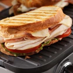 Turkey club panini with lettuce and tomatoes on a griddle, Can You Use a Griddle as a Warming Tray?