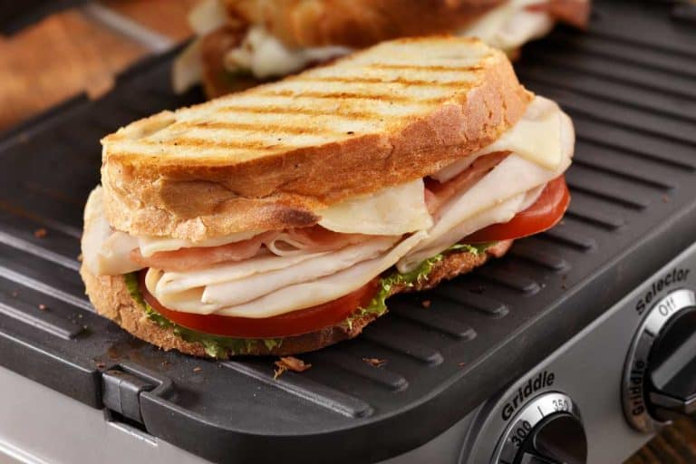 Turkey club panini with lettuce and tomatoes on a griddle, Can You Use a Griddle as a Warming Tray?