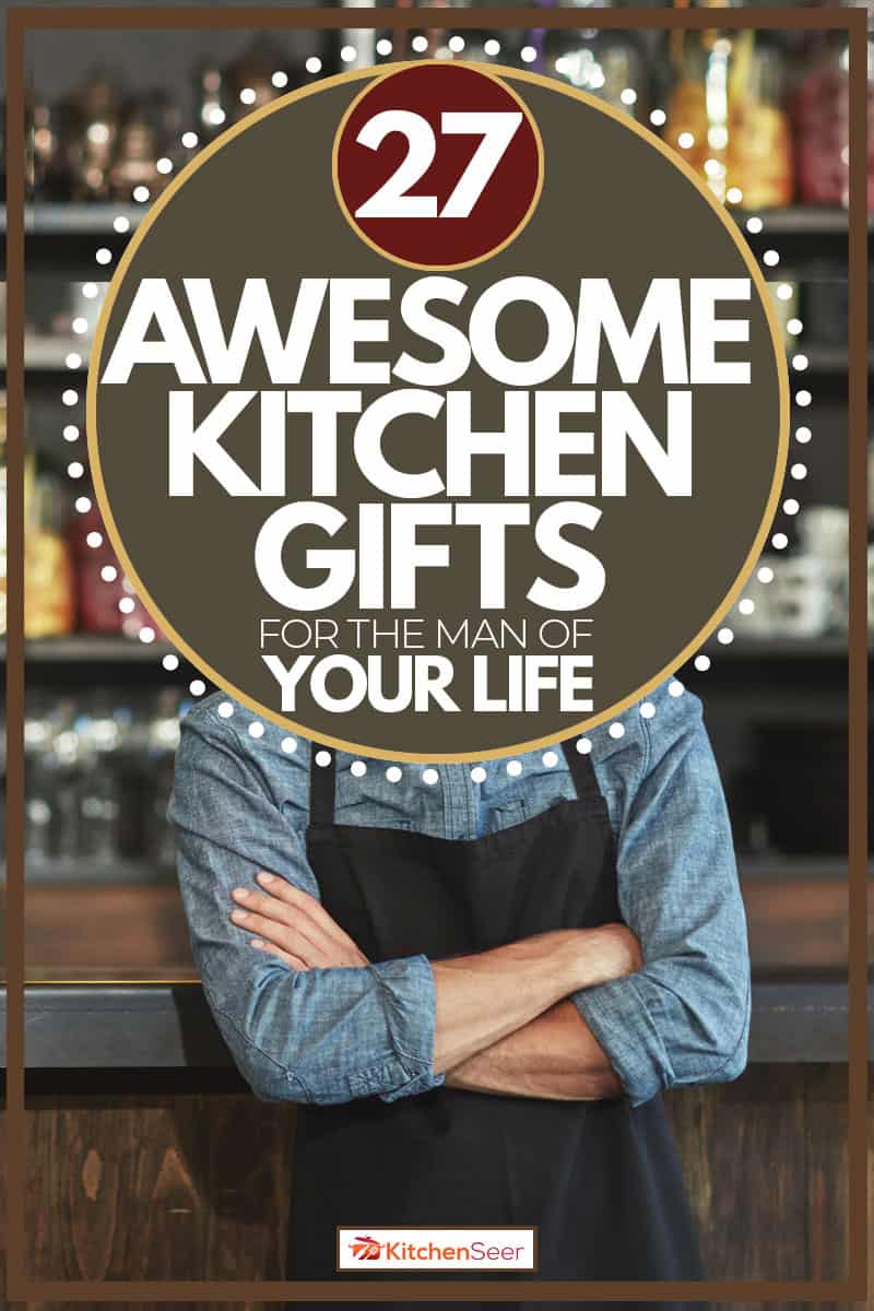 Man with attractive beard wearing black apron as a kitchen gift to him, 27 Awesome Kitchen Gifts for the Man in Your Life
