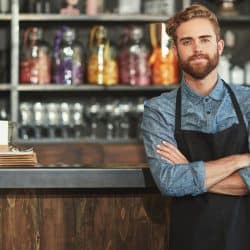 Man with attractive beard wearing black apron as a kitchen gift to him, 27 Awesome Kitchen Gifts for the Man in Your Life