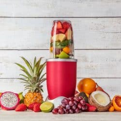 Nutribullet with sliced fruits inside and fruits on the side, ,How Long Does The Nutribullet Last?
