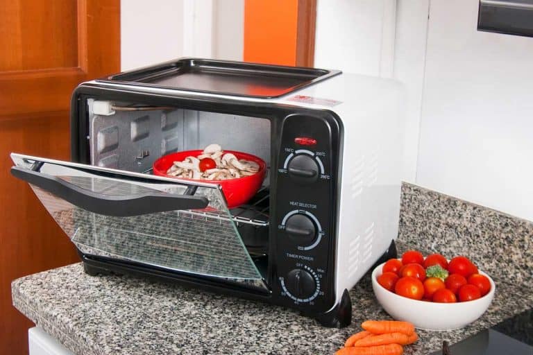 Toaster oven in kitchen environment with red bowl of food inside, Where to Put a Toaster Oven in a Small Kitchen?