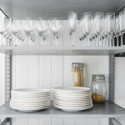 White ceramic plates placed on a metal framed cabinet, Where To Store Plates in the Kitchen