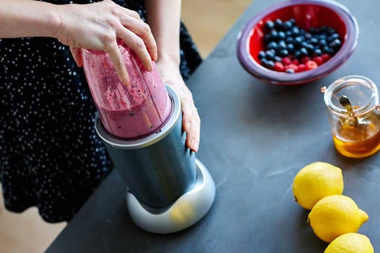 Woman making fruit juice using Nutribullet juicer, Can Nutribullet Go In The Dishwasher?