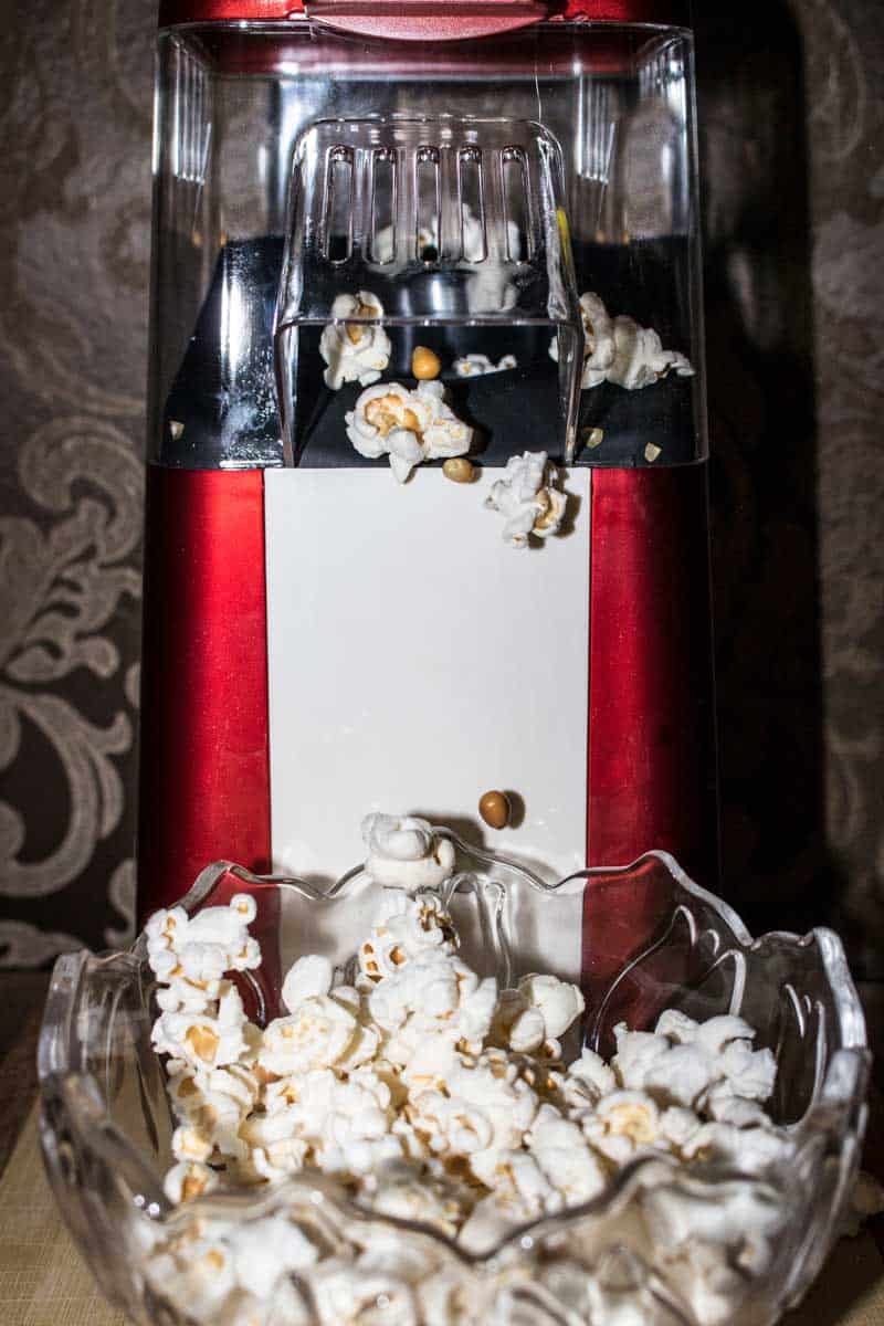 warm popcorn in its flavors with an air poppers at the back