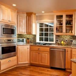 This modern kitchen gives a wide view showing the wood floor and cabinets, How Tall Are Kitchen Cabinets? [3 Types Examined]