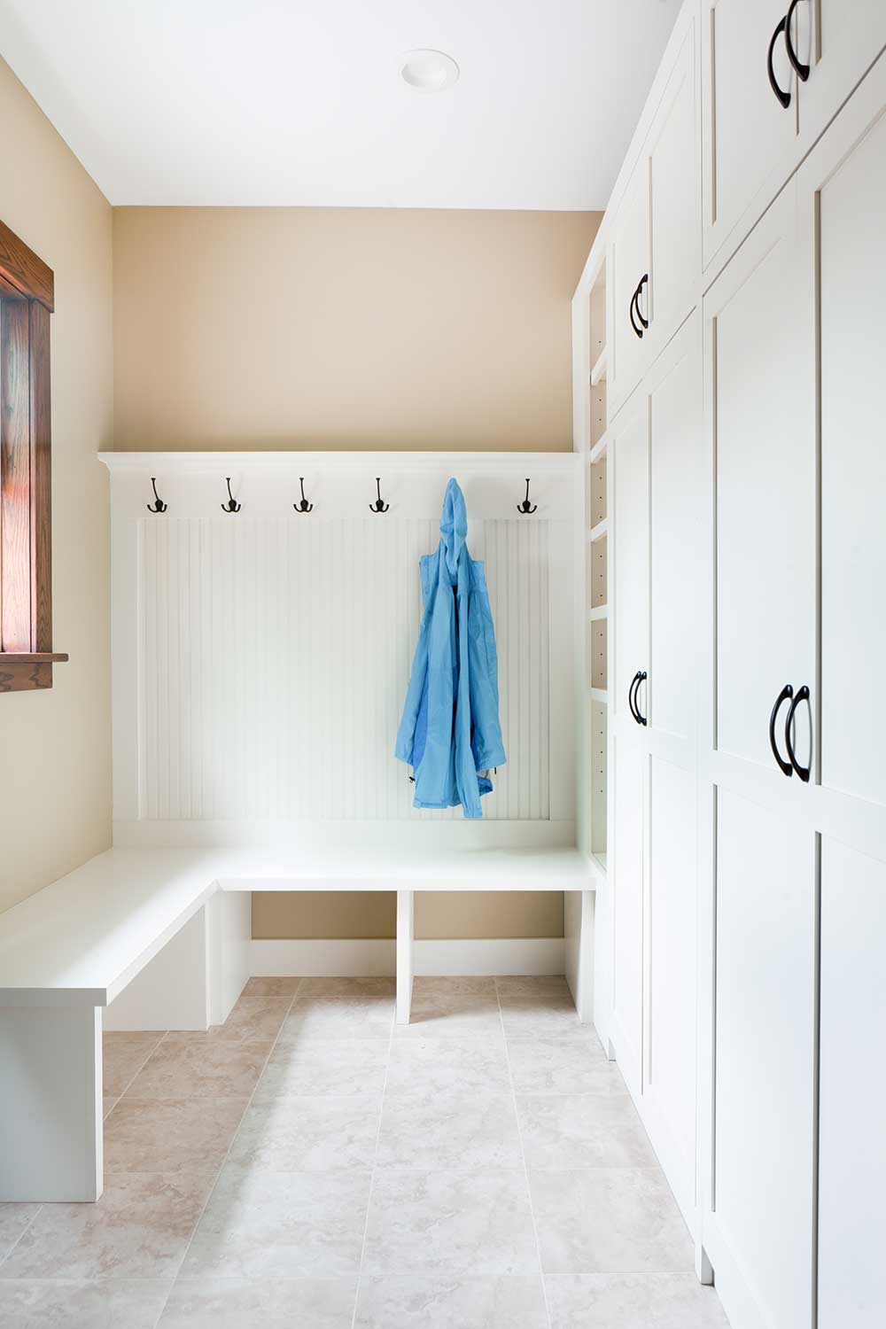 A mudroom home interior space displaying a remodeled entrance and storage room