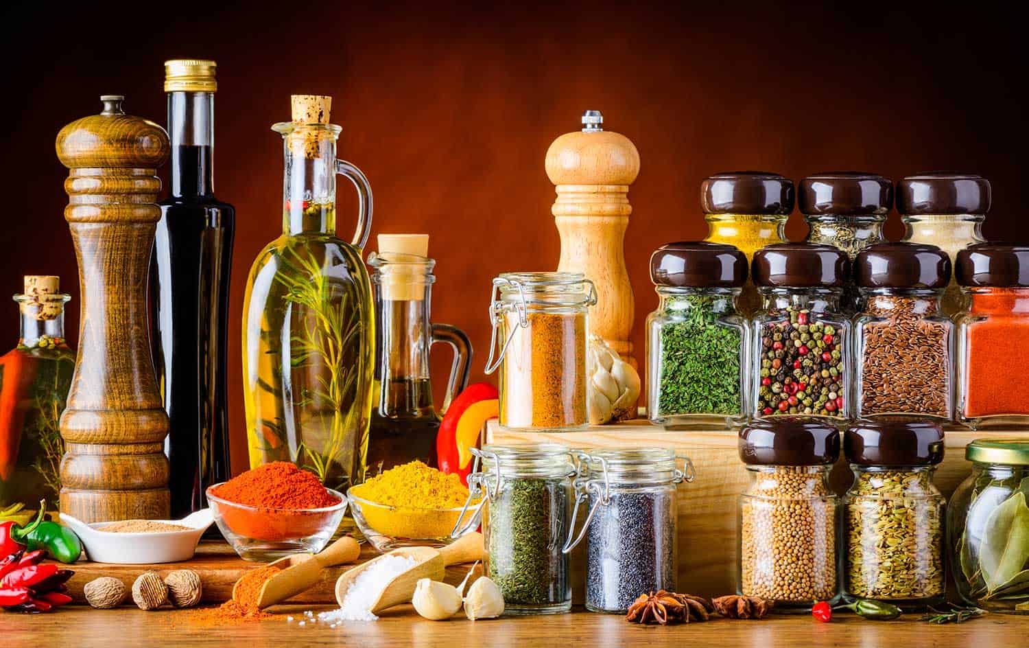 Bottles of oil and Balsamic vinegar and different spices and seeds and cooking ingredients