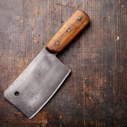 A cleaver knife on a wooden meat cutting board, How Long Is A Cleaver Knife? [And why does it have a hole in it?]