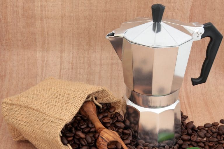 A close up photo of a percolator on top of coffee beans, Can You Use a Percolator on a Glass Stovetop?
