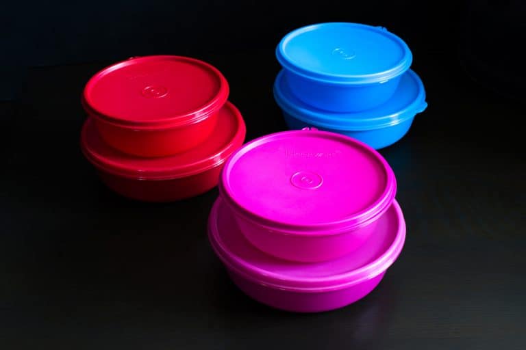A set of tupperware products on a dark background, How To Get Stains Out Of Tupperware [3 easy methods]