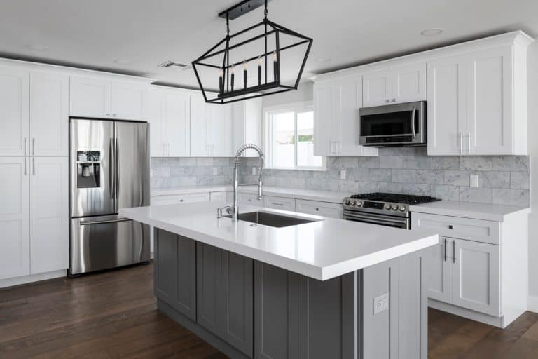 A white and gray themed kitchen with a white granite tiled countertop, Are Kitchen Countertops Glued Down? (And How to Remove Them)