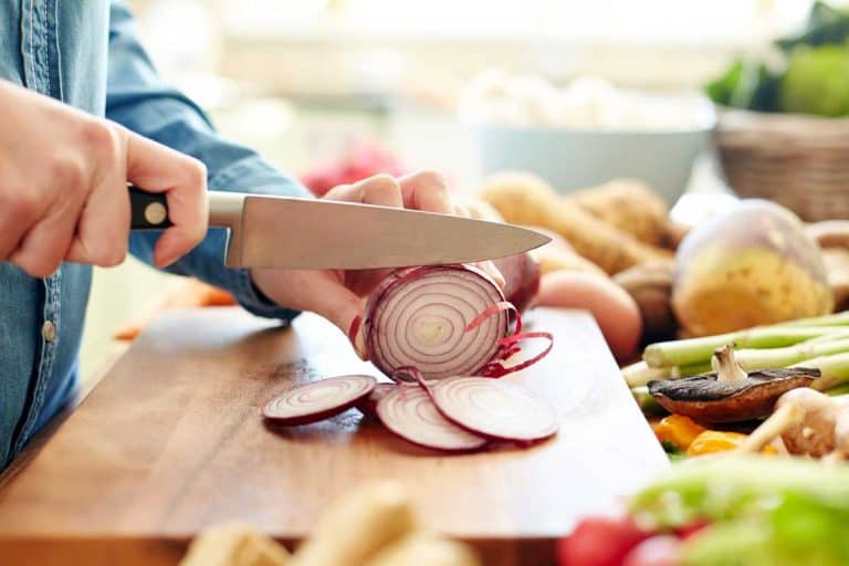 Midsection image of woman cutting onion in kitchen, What Knife Is Best For Cutting Onions?