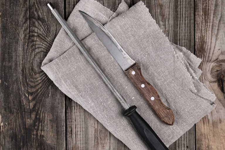 knife with sharpening on the wooden table, top view, How Often To Sharpen Kitchen Knives?