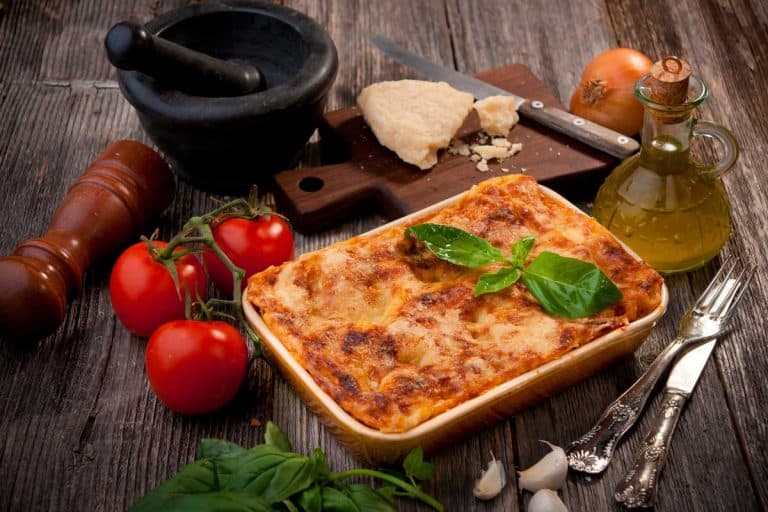 A pan of freshly baked lasagna on a wooden table, Do You Need to Grease a Lasagna Pan?