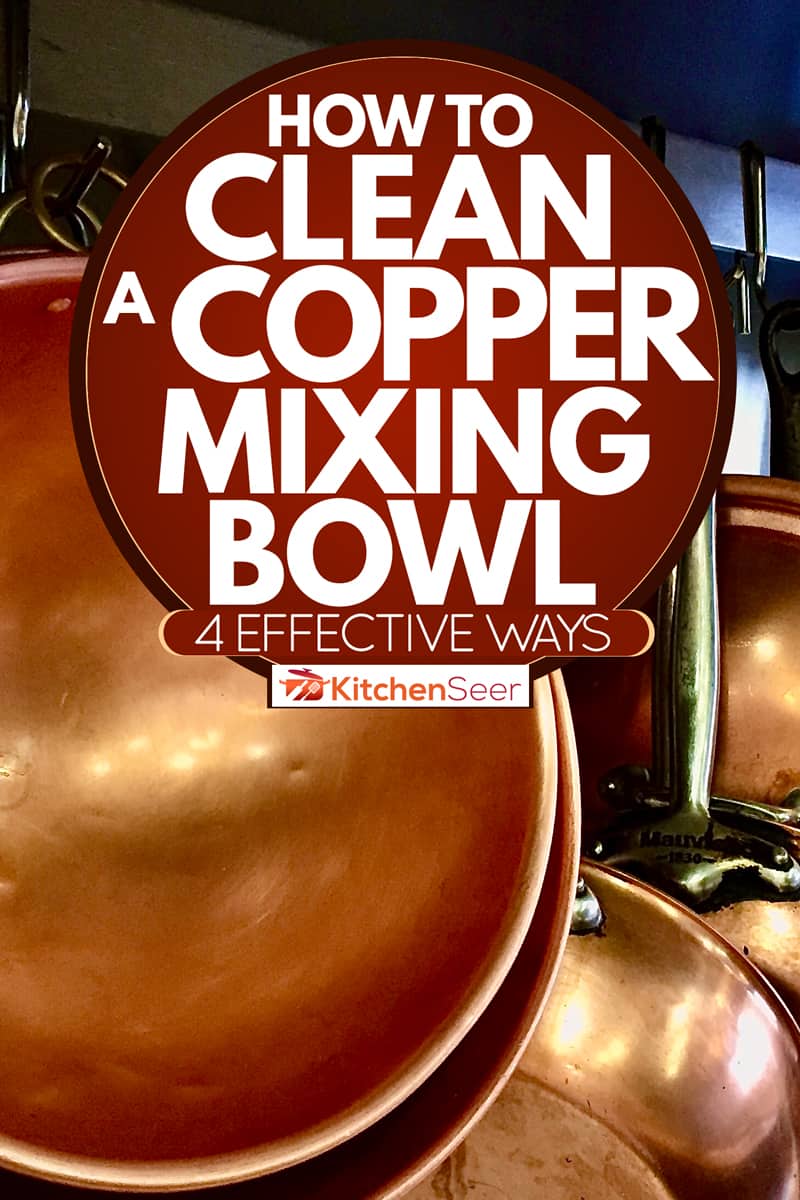 Clean copper sauce pans and mixing bowls hanged on a restaurant wall, How To Clean A Copper Mixing Bowl [4 Effective Ways]