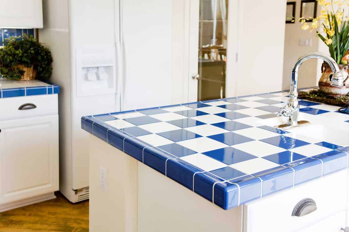 Modern kitchen interior with checkered white and blue tile.