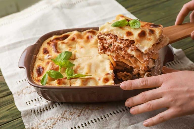 Taking of piece of tasty lasagna from casserole, How Many Layers Should a Lasagna Be? Here's the Answer!