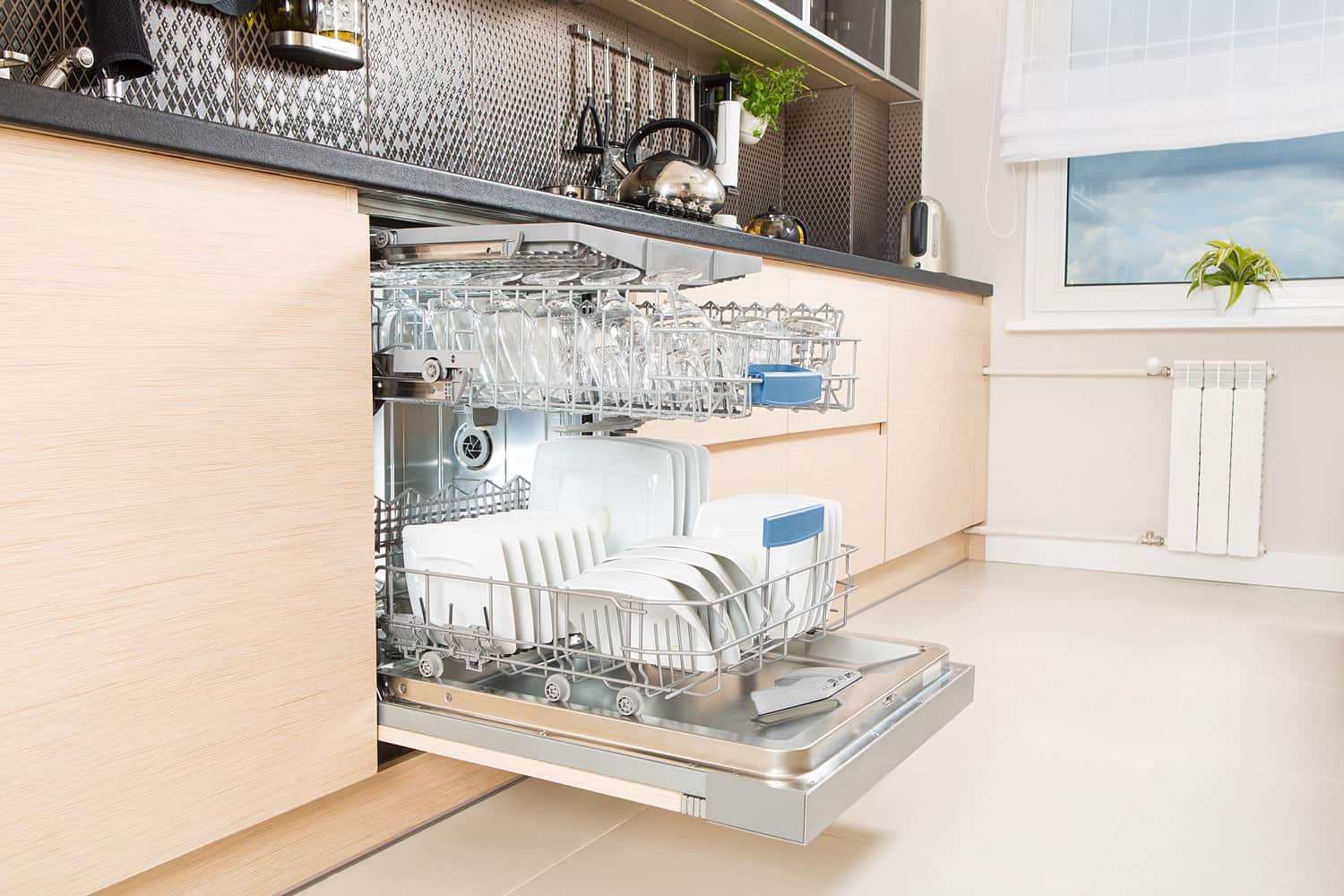 A dishwashing rack with plates and glass on it