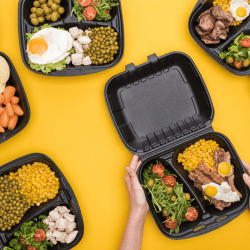 Cropped view of woman holding plastic food container with corn, meat, fried eggs and salad isolated on yellow stock, How to Remove Food Smells And Stains From Plastic Containers?