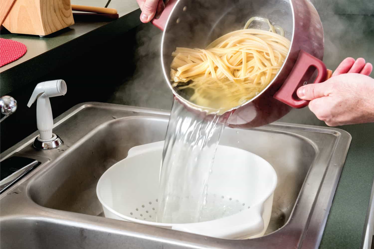 Draining Fettuccine in a Colander on a kitchen sink