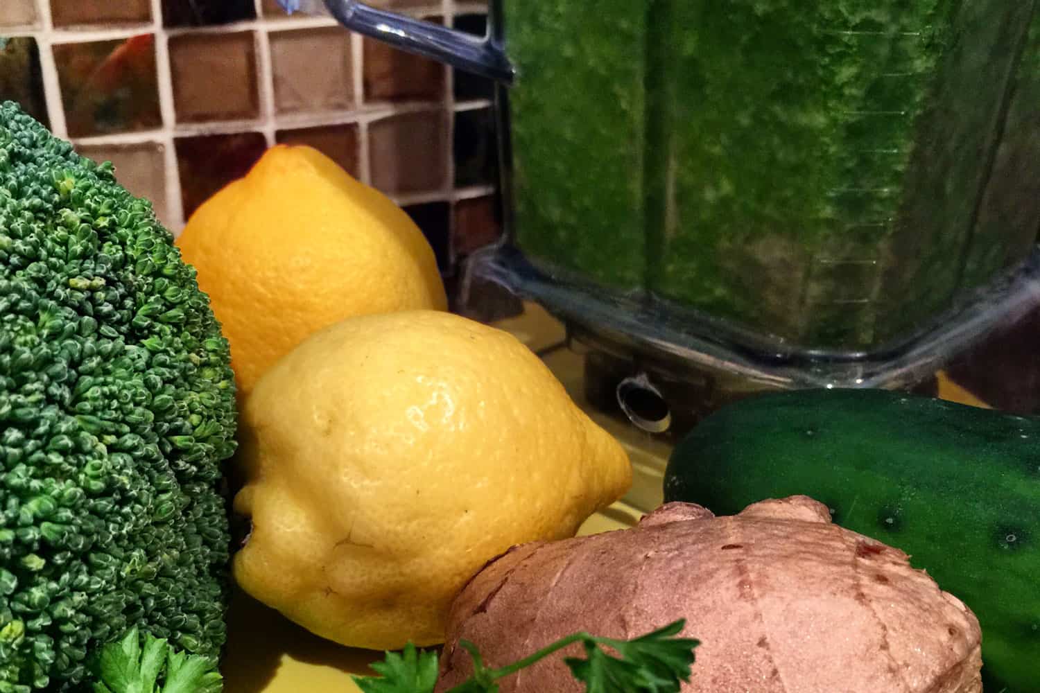 Green smoothie in blender with healthy ingredients