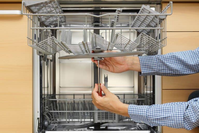 Handyman repairing a dishwasher, KitchenAid Dishwasher Stops Mid-Cycle - What To Do?