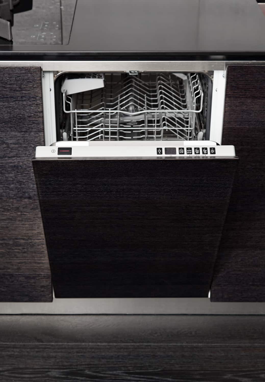 Open GE dish washer machine on black hardwood kitchen