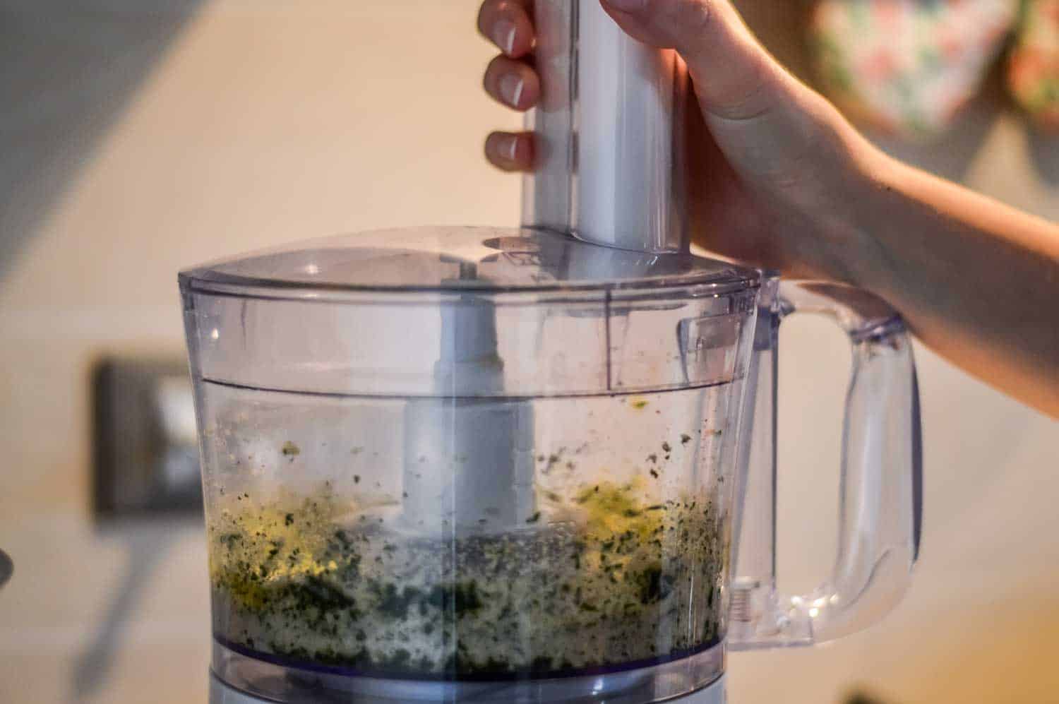 Parsley and bread crumbs on electric blender bowl