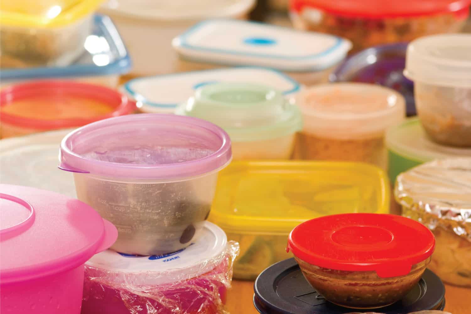 Several plastic food containers with leftovers