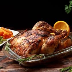 Traditional English Roast Chicken marinated with Herbs and Spices served with Roast Potatoes and Vegetables as a side dish roasted in the oven, Traditional English Roast Chicken marinated with Herbs and Spices served with Roast Potatoes and Vegetables as a side dish