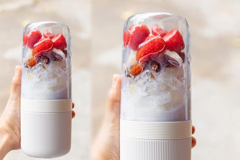 Woman hand holding portable blender with healthy fruits; getting ready for making a smoothie. Fresh strawberry, banana, almond, honey and milk with ice; healthy and fresh concept, featured, Are Blender Bottles Dishwasher-Safe?