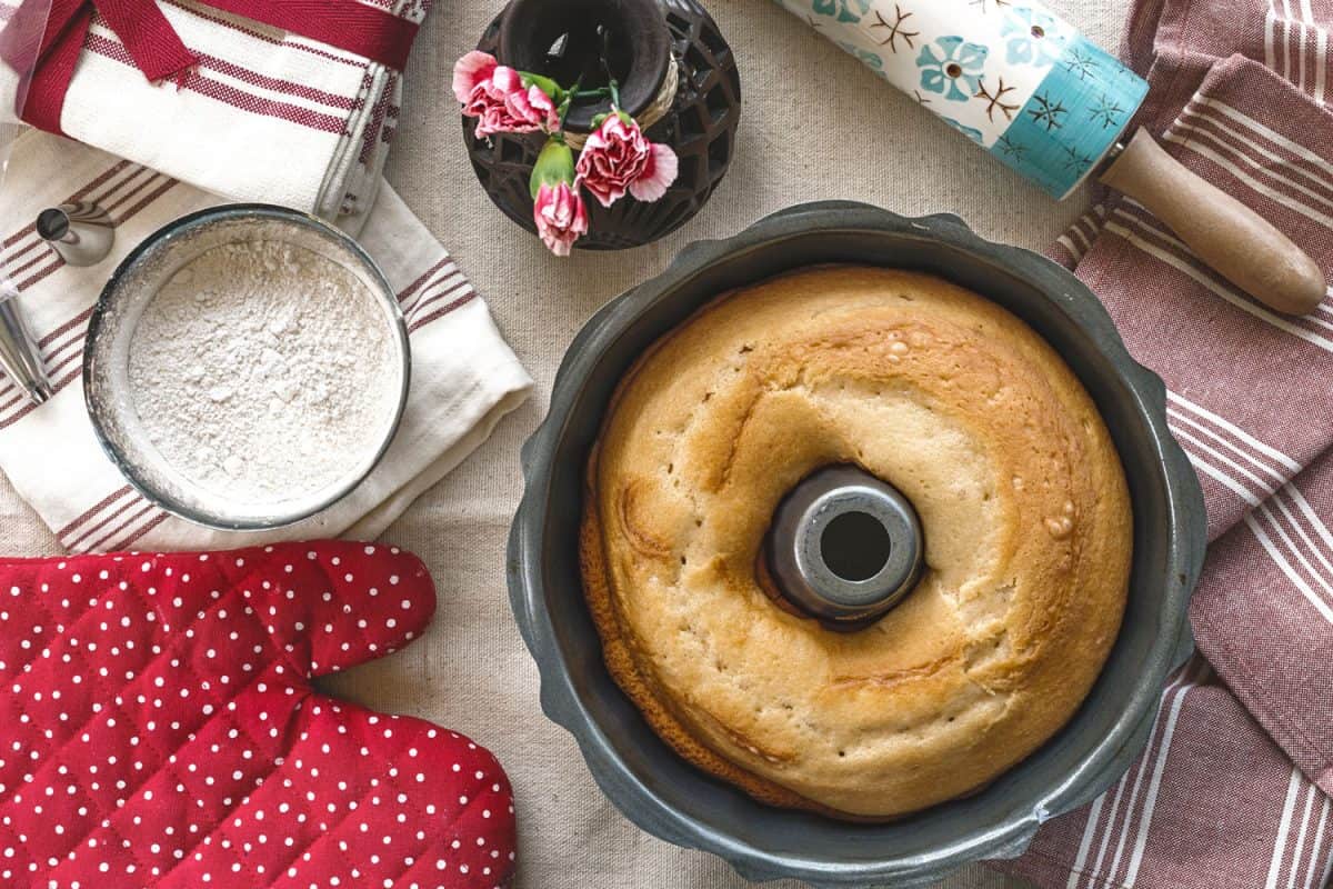 A home made Bundt cake with ingredients placed on the side