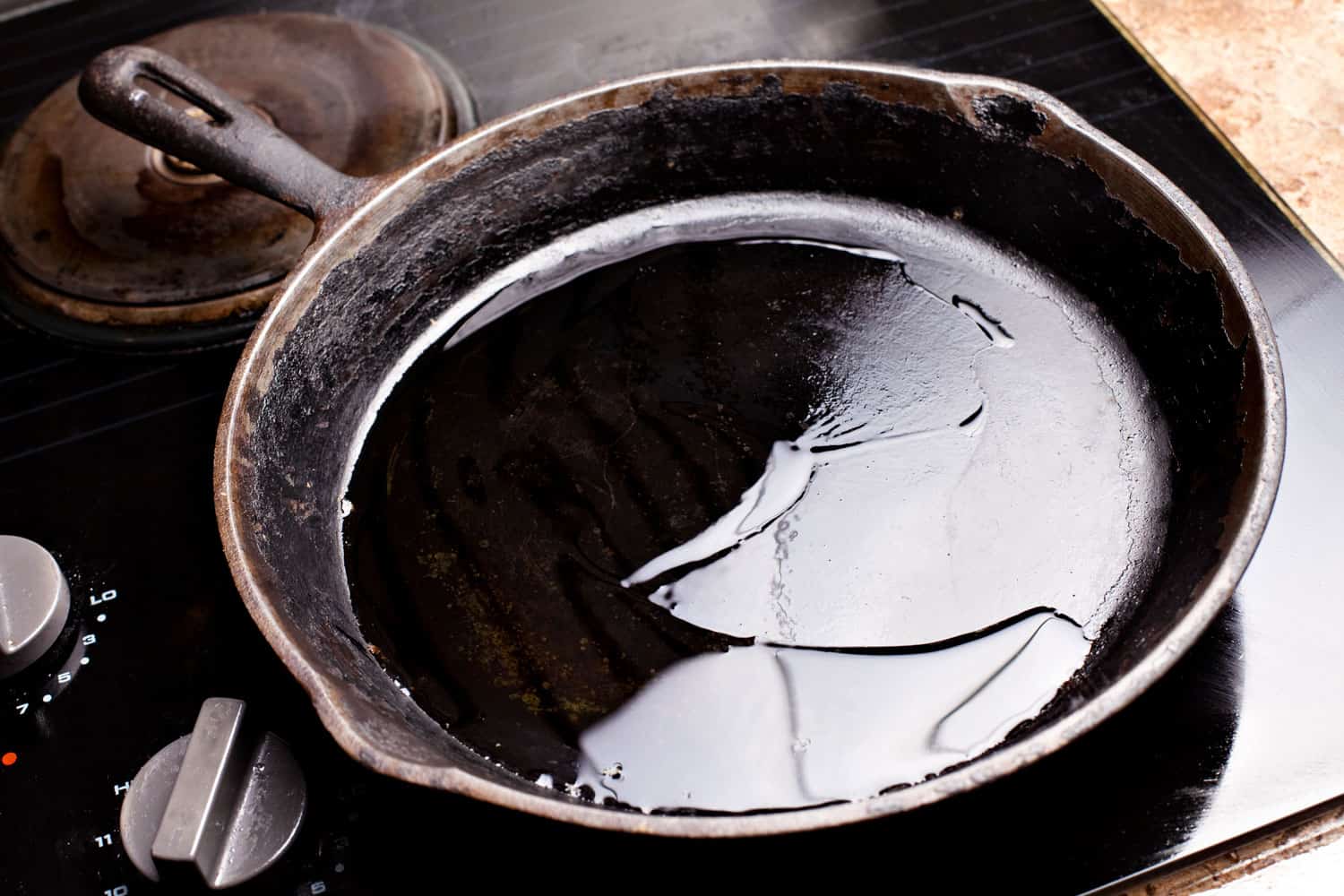 An old frying pan with cooking oil on it
