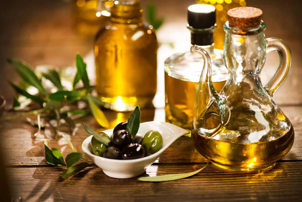 Bottles of olive oil with olives
