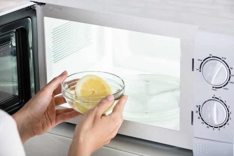 Close-up of woman putting bowl of slice lemon in microwave oven, If A Bowl Is Microwave Safe Is It Also Oven Safe?