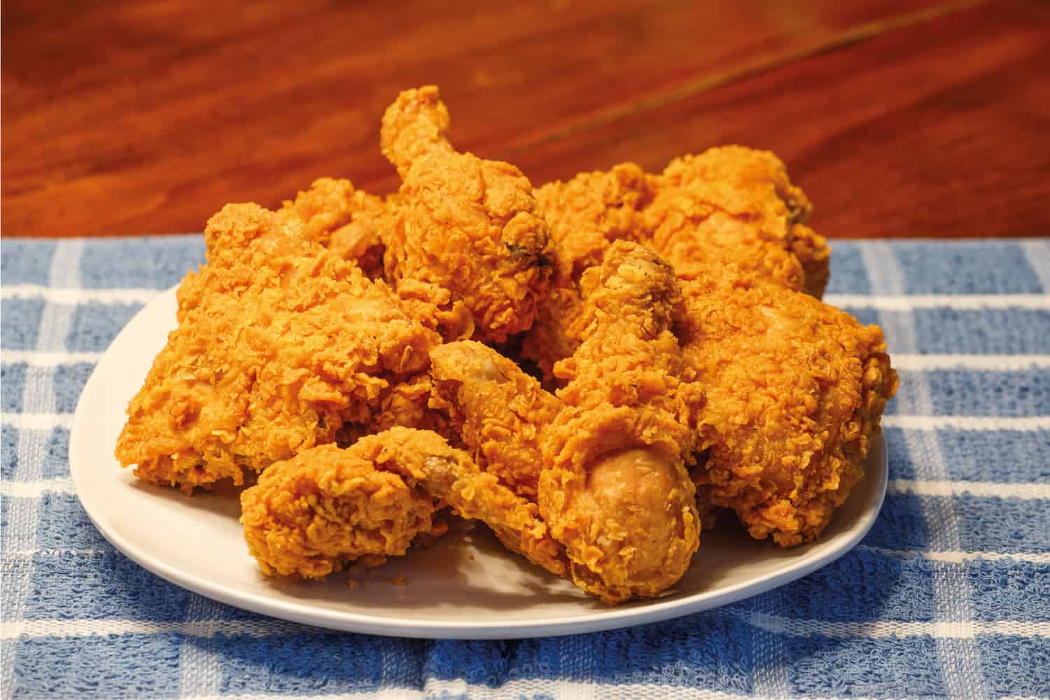 A Plate of Fresh Fried Chicken on Blue Plaid Placemat