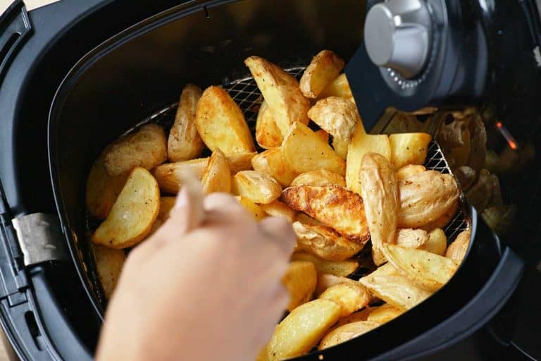 A homemade grilled potato inside an Air Fryer, How To Air Fry Potatoes - With 10 Tasty Recipes!