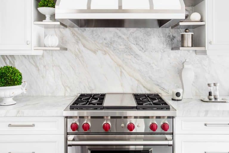 Bright classic white kitchen with gas range and marble backsplash, How Much Space Should There Be Between The Range And Wall?