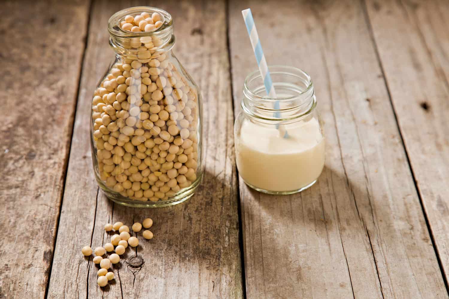 Soy beans and soy milk on a wooden table