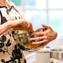 A woman uses a mixing bowl for baking, When Should You Not Use Metal Mixing Bowls?