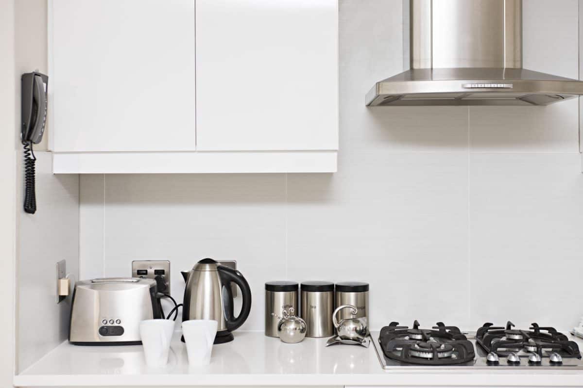 Different sets of kitchen appliances inside a modern living room 
