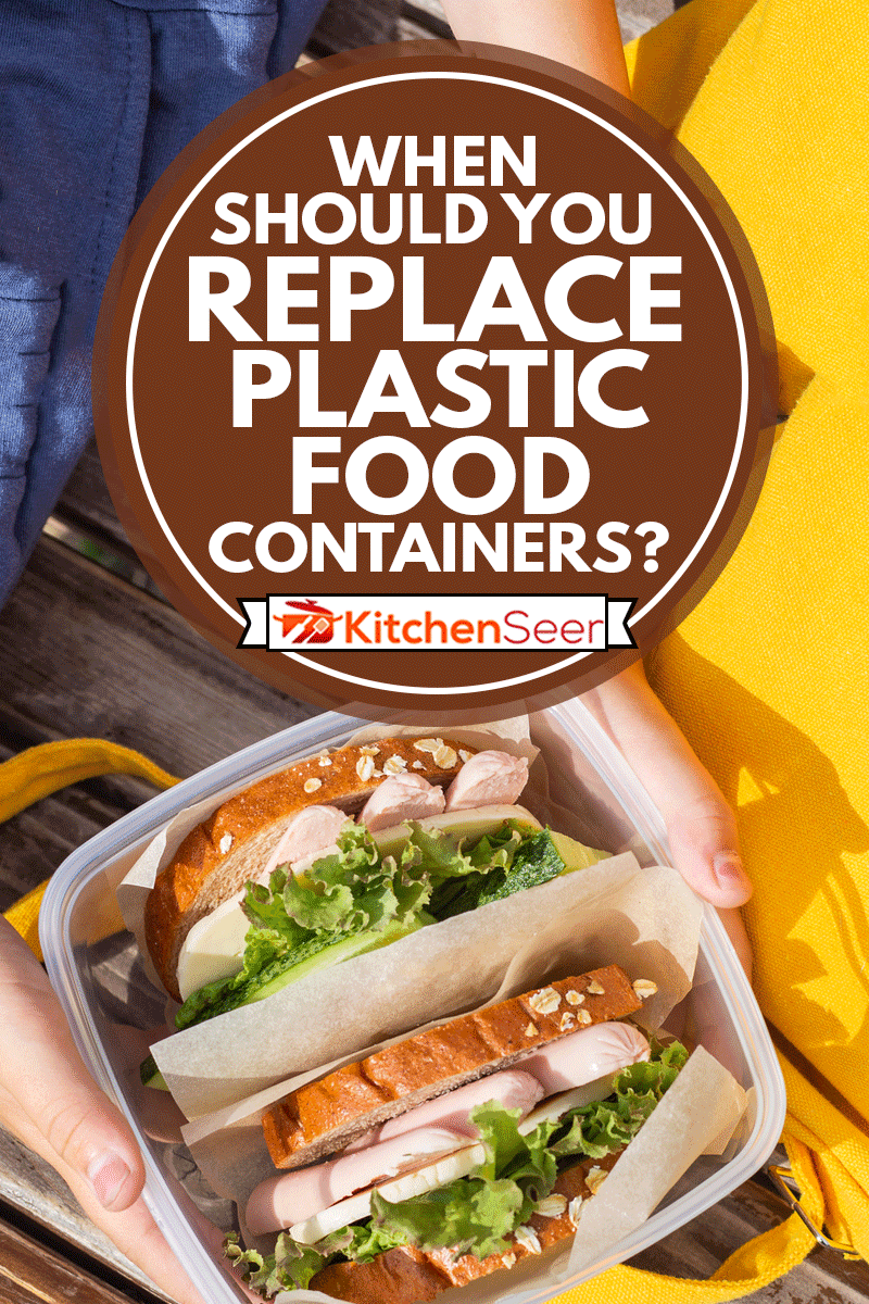 Lunch box in the hands of a child. Sandwiches with bread, lettuce, cucumber and sausages in a plastic container, When Should You Replace Plastic Food Containers?