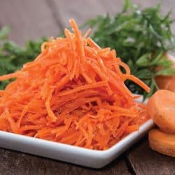 small plate with carrot salad, shredded carrots. How To Shred Vegetables In A Food Processor In 4 Easy Steps