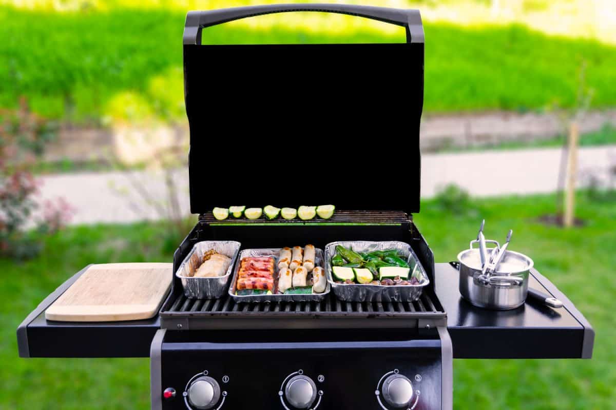 A gas griller with vegetables placed on top